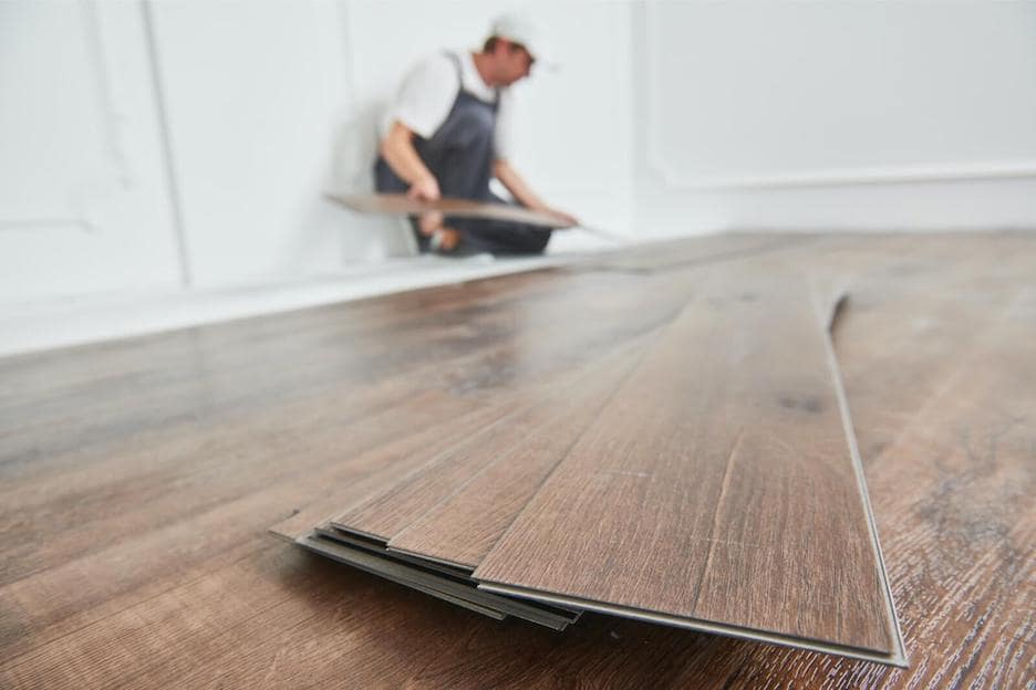 man installing laminate floors