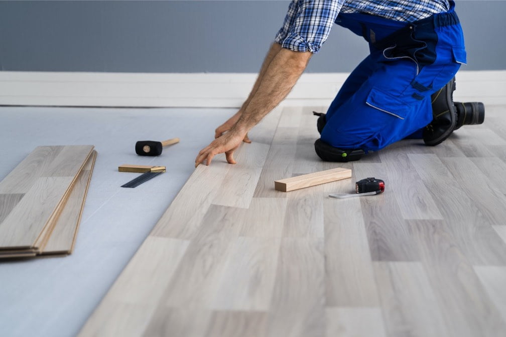 Licensed professional installing vinyl flooring