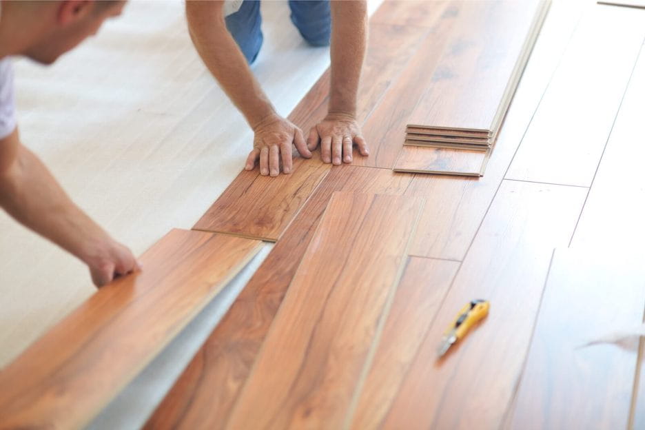 Professional installation crew installing laminate flooring